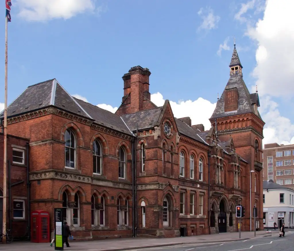 Victorian heritage building with lead-clad slate roof, dormers and tower