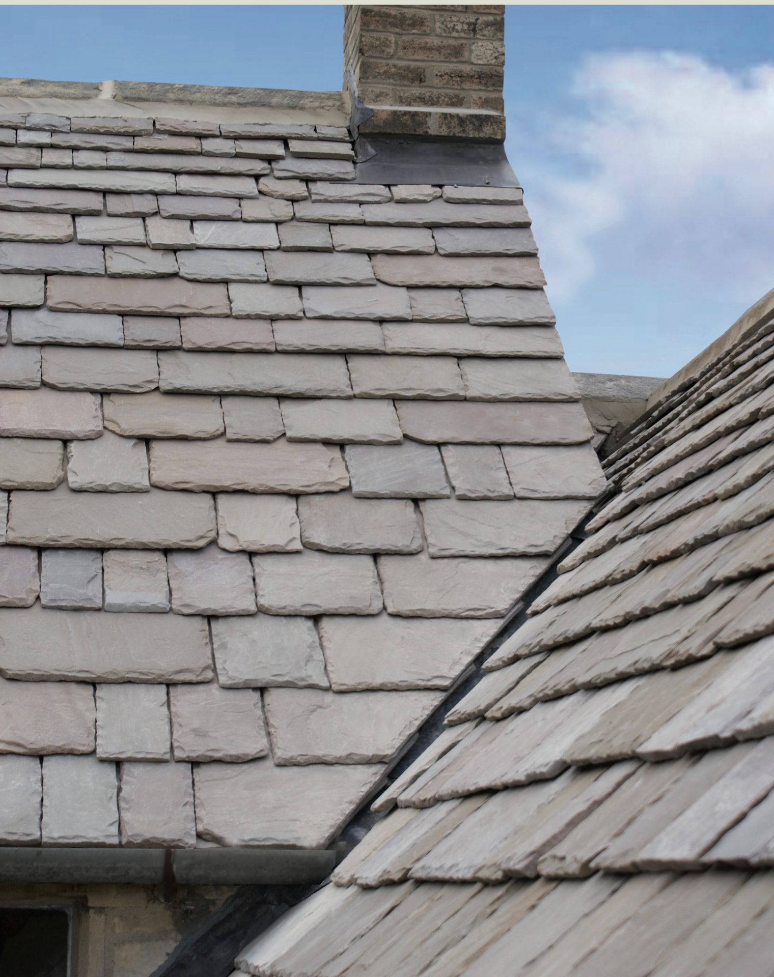 Cotswold roof stone meeting a stone chimney stack