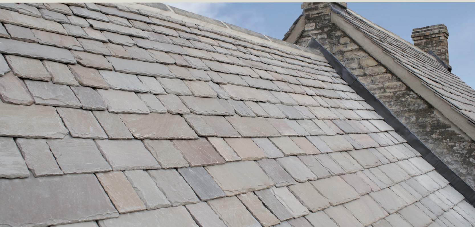 Cotswold stone roof sweeping up to the ridge