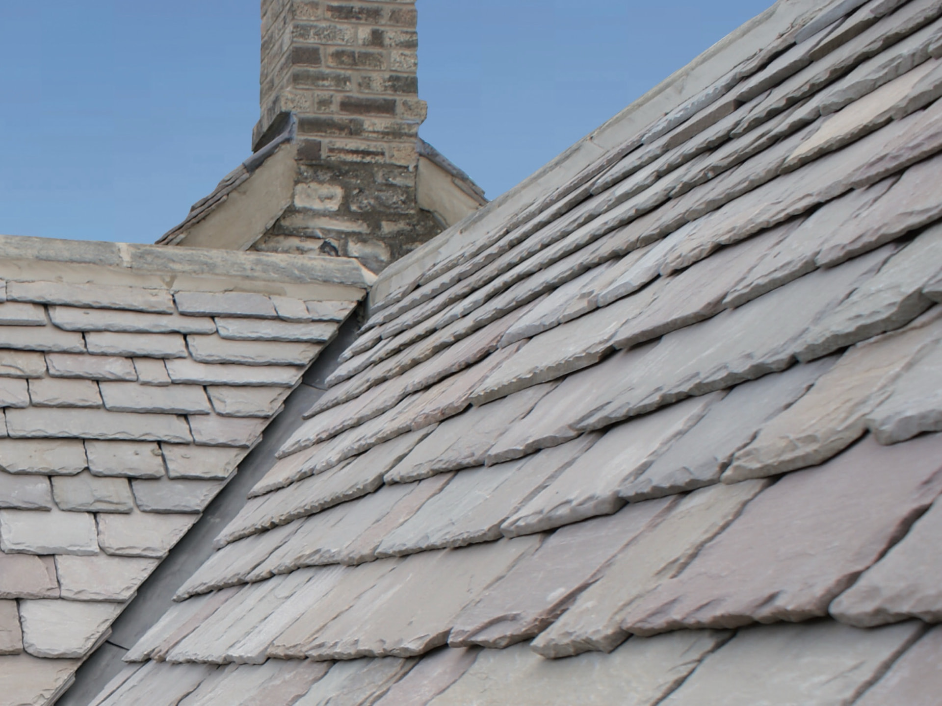 Close view of stone slate courses, showing the varied sizes and riven edges.