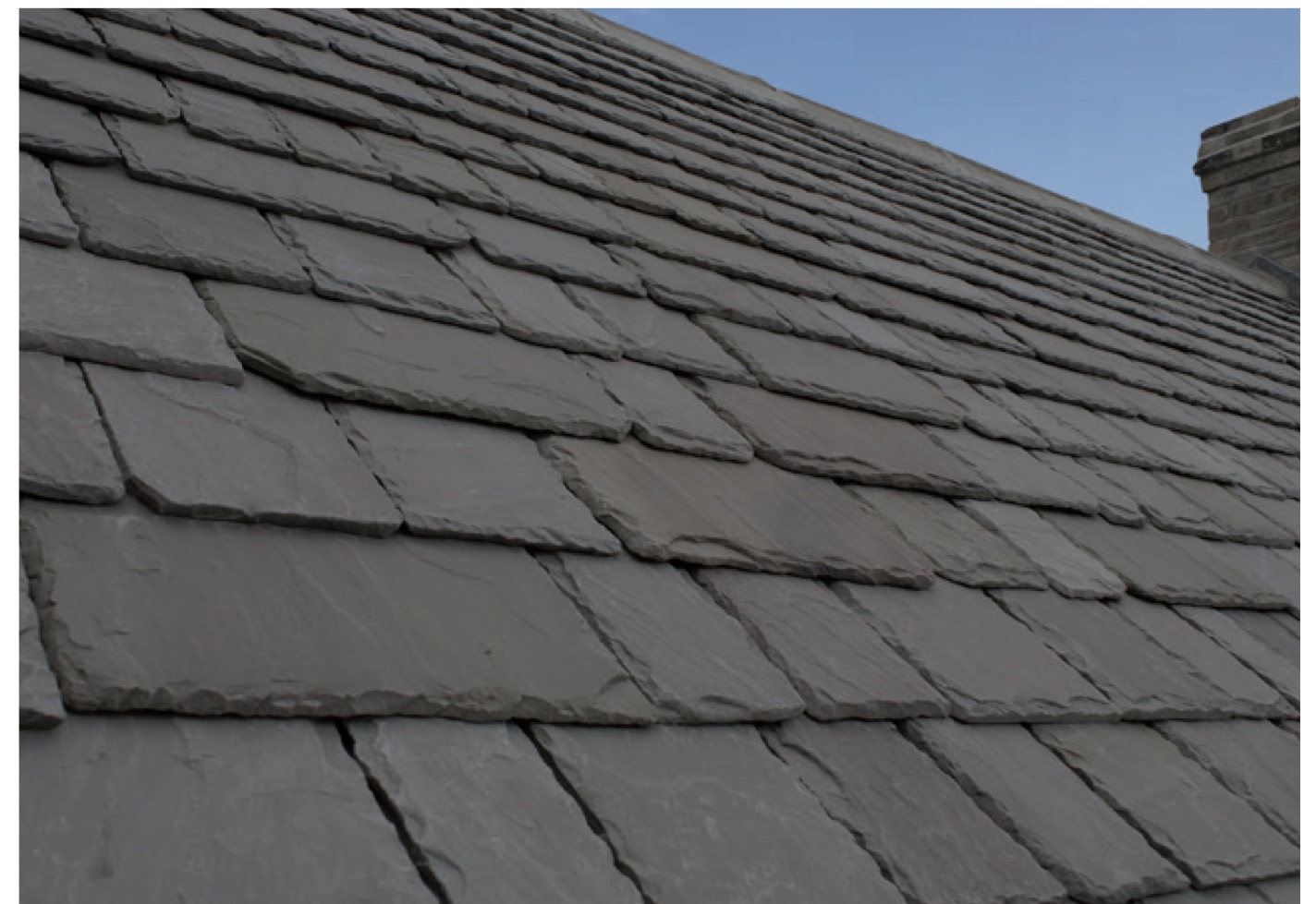 Cotsway Aged natural roof stone on a pitched Cotswold roof