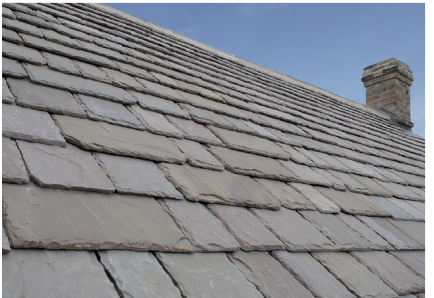 Cotsway Buff natural roof stone with a stone chimney